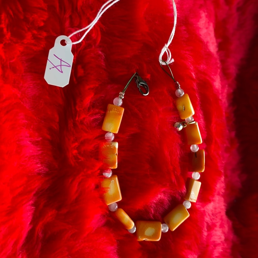 Bracelet with orange coral shell.